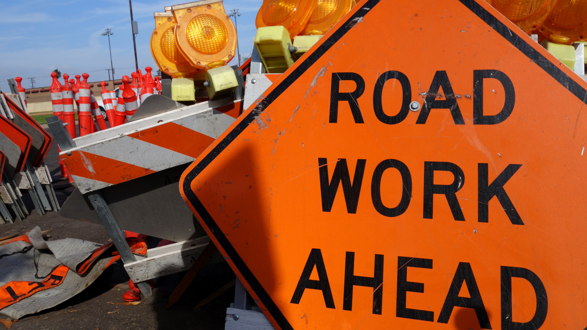 Photo of construction safety equipment and road work ahead sign