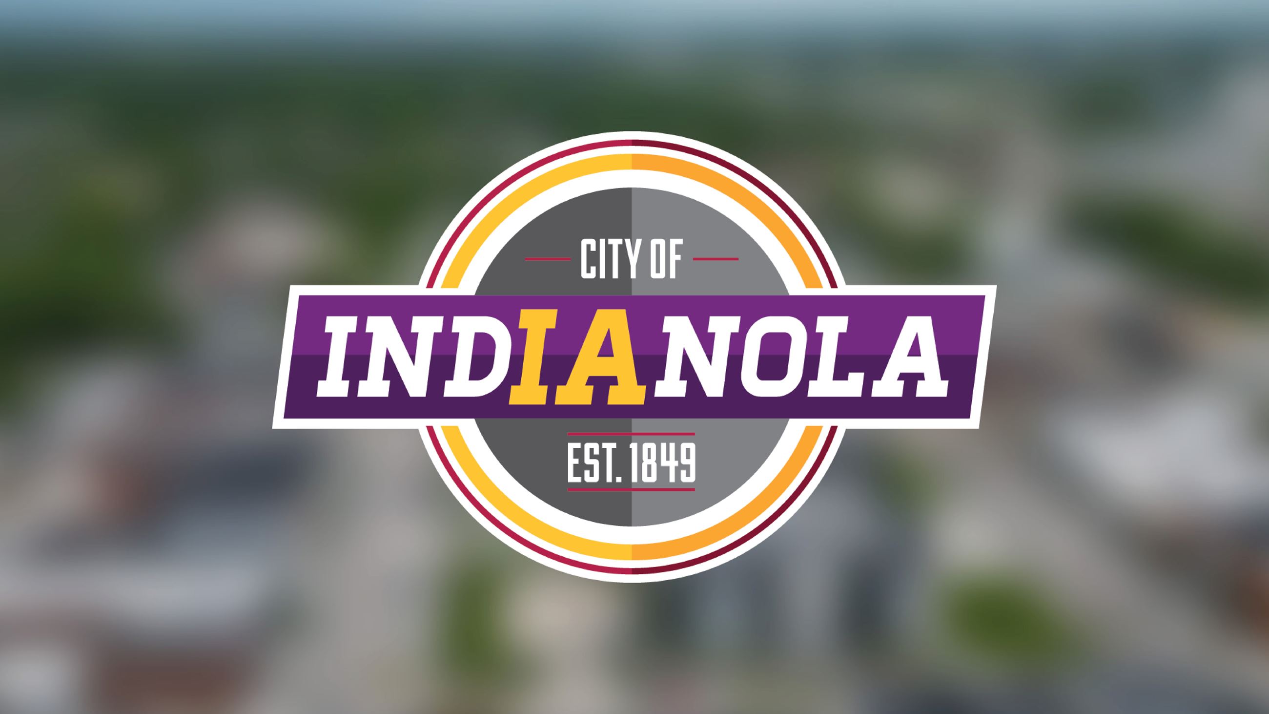 Aerial photo of downtown Indianola with the City of Indianola logo.