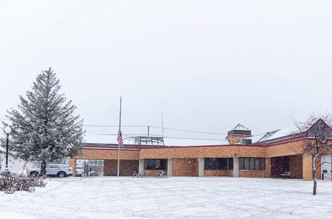 Exterior of Indianola City Hall as snow falls.