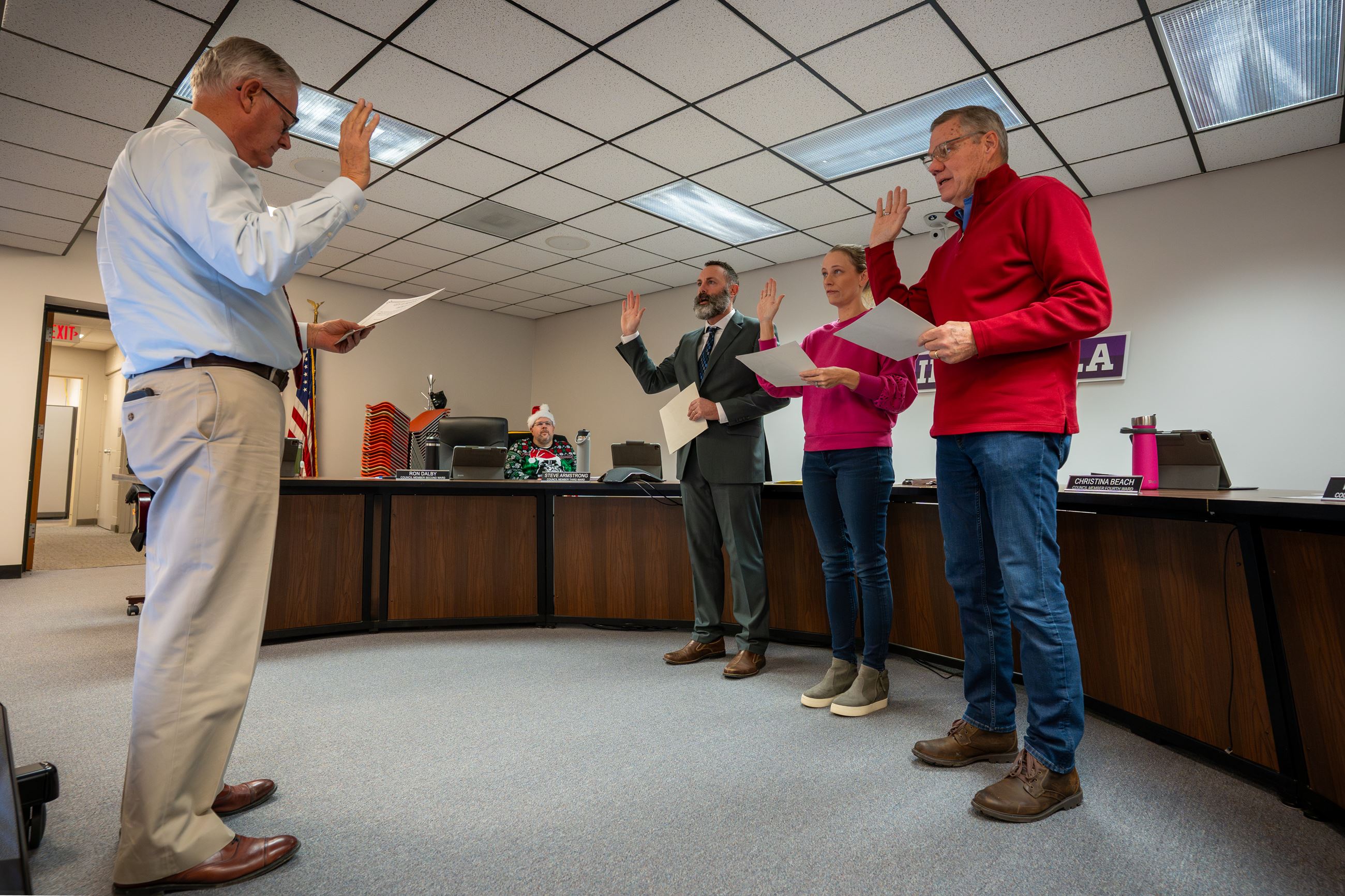 Group of individuals taking oath of office to serve on Indianola City Council