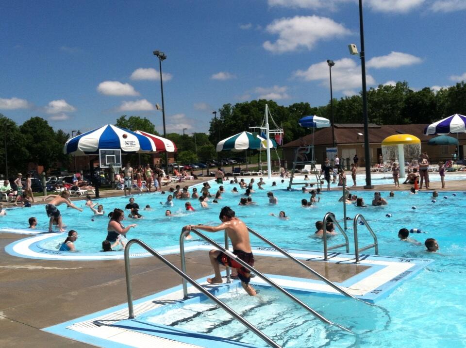 Swimmers enjoy the water while others enjoy shade at the Veterans Memorial Aquatic Center